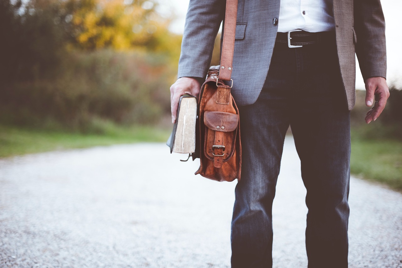 Business person with bag, holding book to apply for MBA